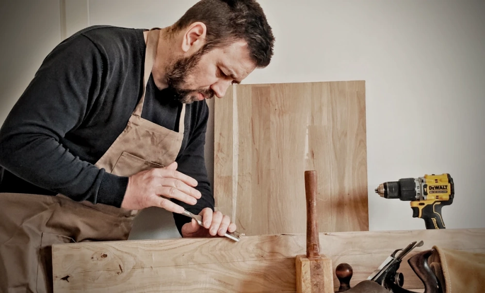 Matt Bedford working at the bench, hand-finishing a piece of oak